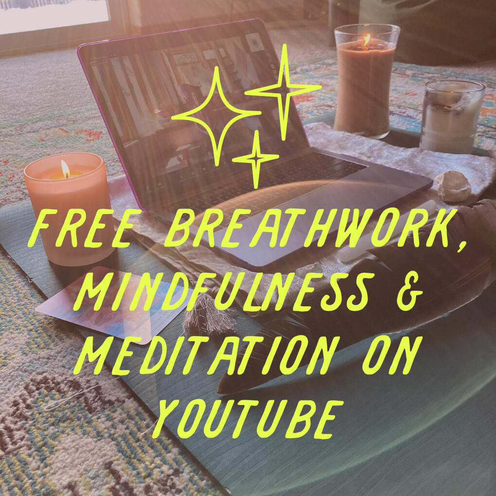 Laptop and ritual tools on a yoga mat on the floor with the words "free breathwork, mindfulness & meditation on YouTube" overlayed in playful font.